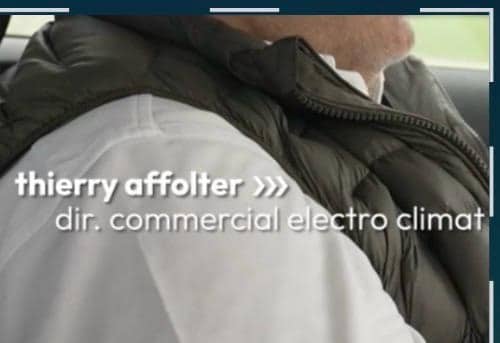 Plan rapproché d'un homme en chemise blanche et veste matelassée verte, avec l'incrustation télévisée thierry affolter, dir. commercial electro climat